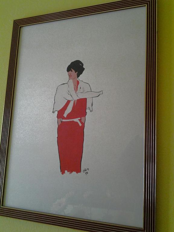 a picture of a woman with her arms crossed at Hotel Su Giudeu in Chia