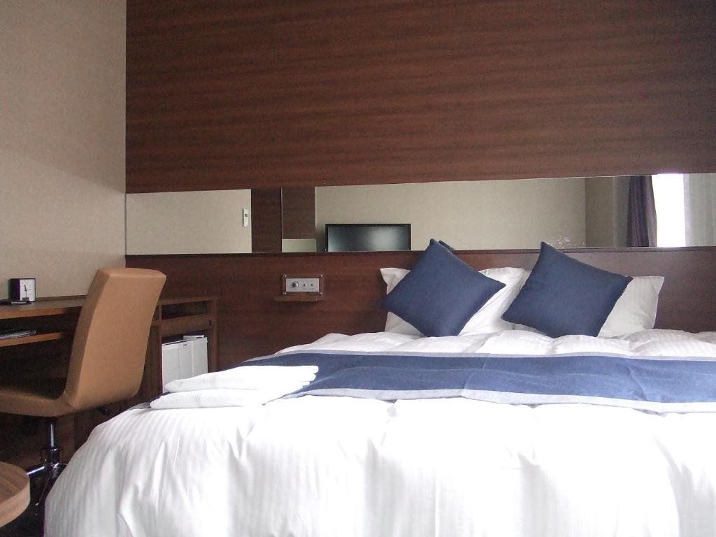 Postel nebo postele na pokoji v ubytování Hotel Il Credo Gifu