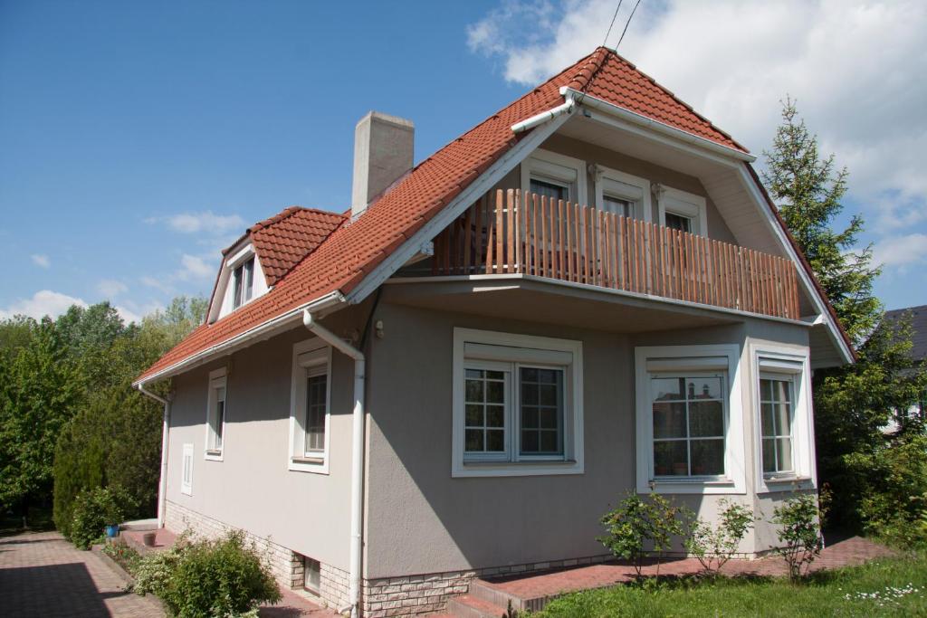 a house with a deck on the side of it at Bodza Vendégház in Balatonfüred