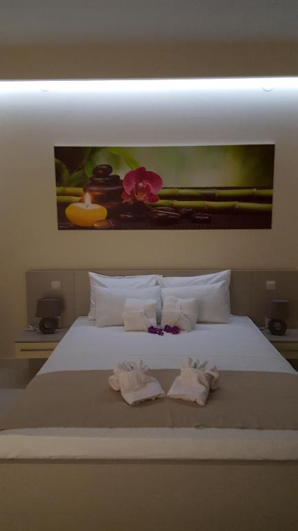 a bedroom with a bed with two towels on it at Guesthouse Laterna in Herceg-Novi