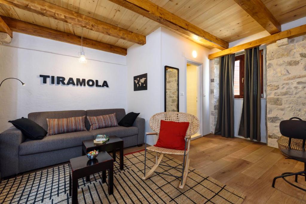 a living room with a couch and a red pillow at Apartments & Rooms Tiramola - Old Town in Trogir