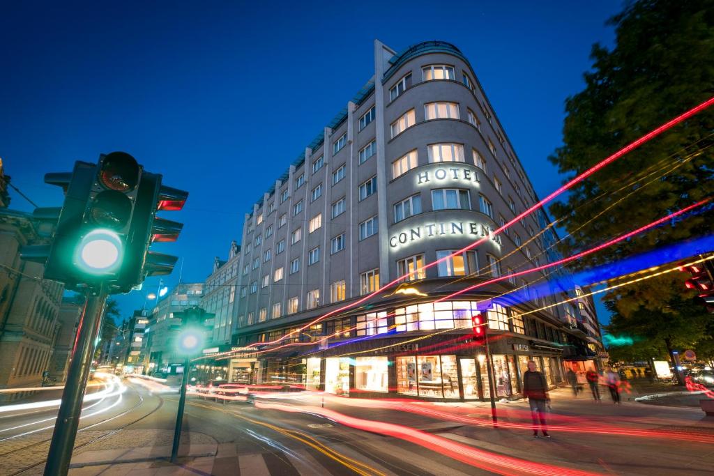 a building on a city street with a green traffic light at Hotel Continental in Oslo