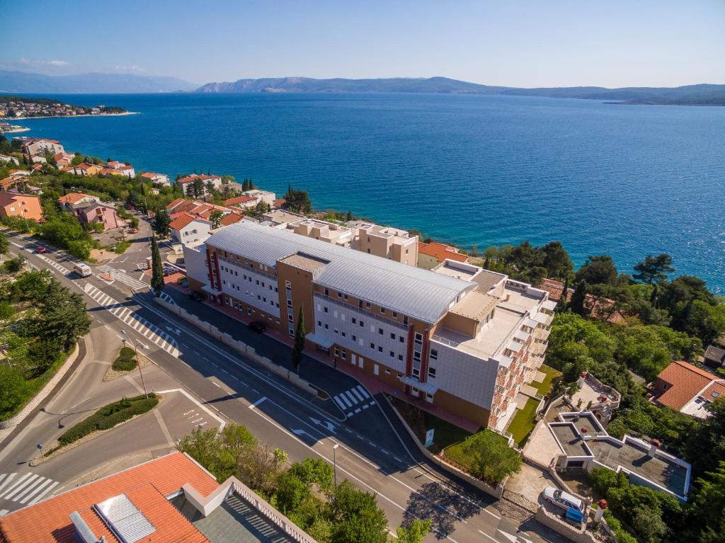 an aerial view of a building next to the water at Crikvenica Residence Apartments and Rooms in Crikvenica