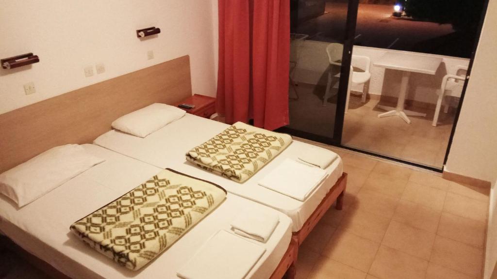A bed or beds in a room at Kyriakos Studios