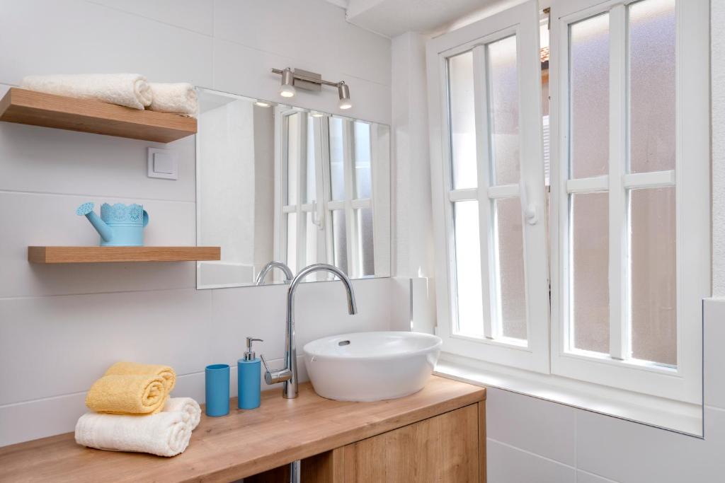 a bathroom with a sink and a window at Villa Riva in Jelsa