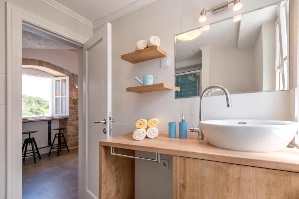 a bathroom with a sink and a mirror at Villa Riva in Jelsa