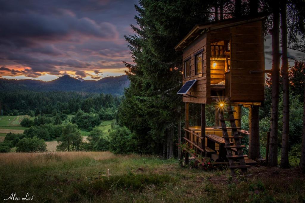 a tree house in the woods at sunset at Tree House Gorski Lazi in Tršće