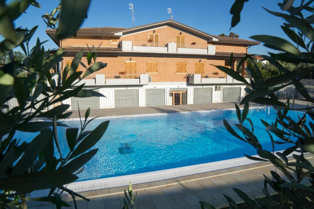 a large swimming pool in front of a building at Villa Emilia in Fossacesia