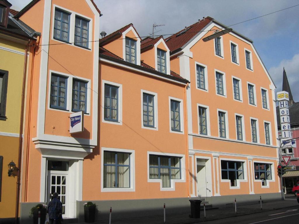 ein orangefarbenes Gebäude an der Straßenseite in der Unterkunft City Hotel Neuwied in Neuwied