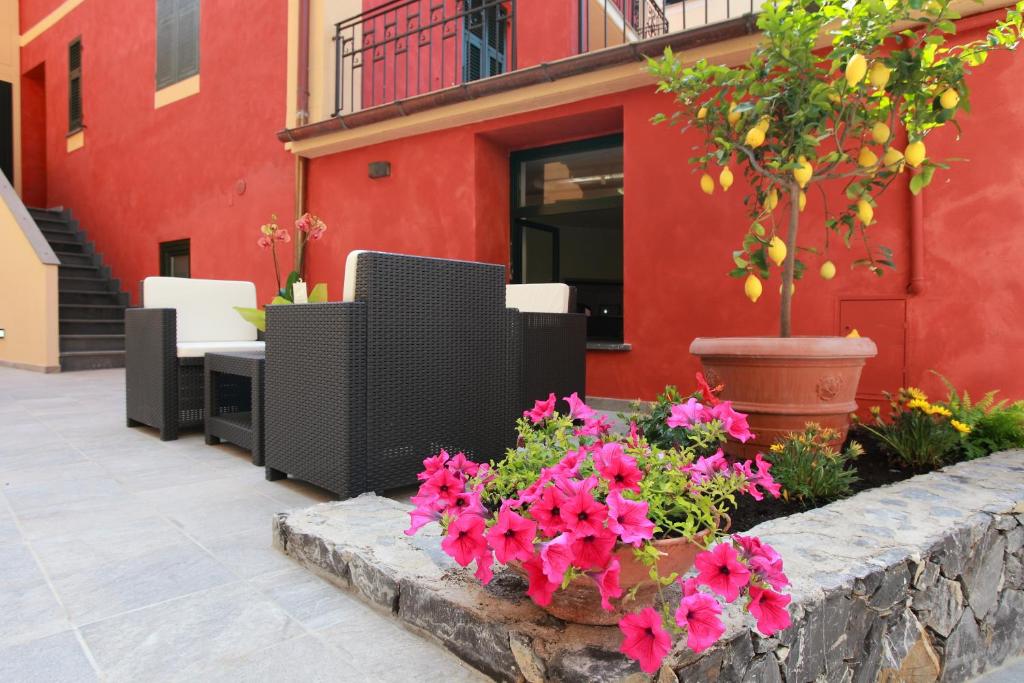 a retaining wall with flowers in front of a building at Hotel Margherita in Monterosso al Mare