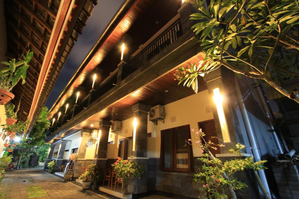 a building with lights on the side of it at Surya Inn in Kuta