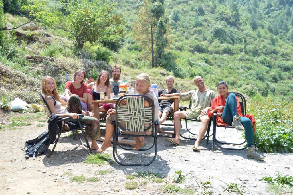 a group of people sitting around a table in chairs at Dhanaulti Camp Homes Retreat in Dhanaulti