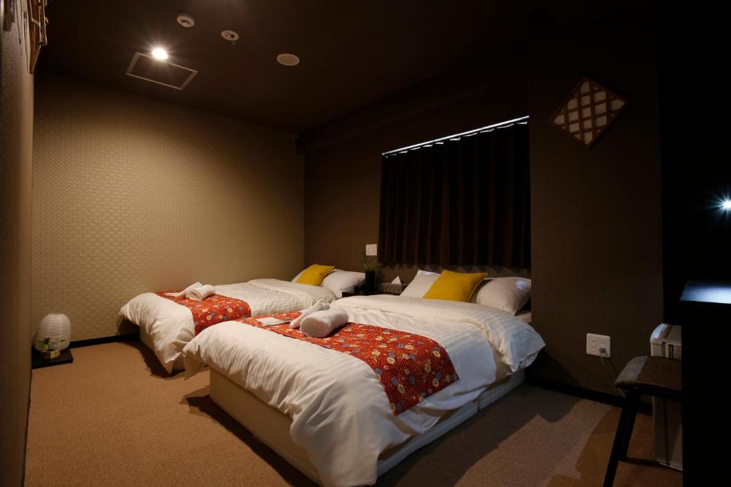 Postel nebo postele na pokoji v ubytování Sumiya Spa & Hotel