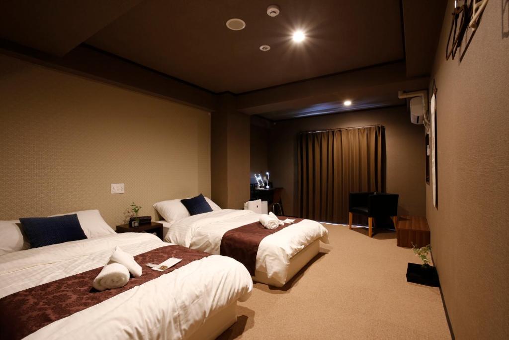 Postel nebo postele na pokoji v ubytování Sumiya Spa & Hotel
