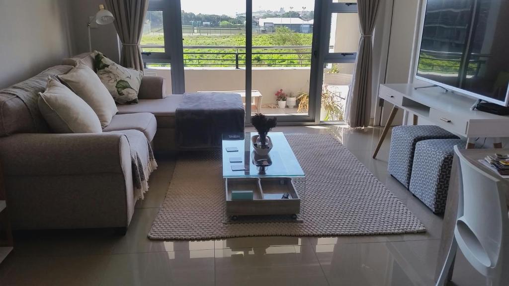 a living room with a couch and a coffee table at Ashton Apartments Central Park in Durban