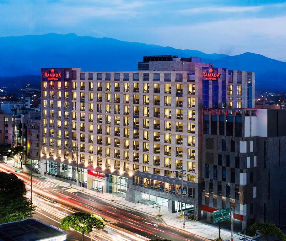 a large building with lights on top of it at Ramada by Wyndham Jeju City Hall in Jeju