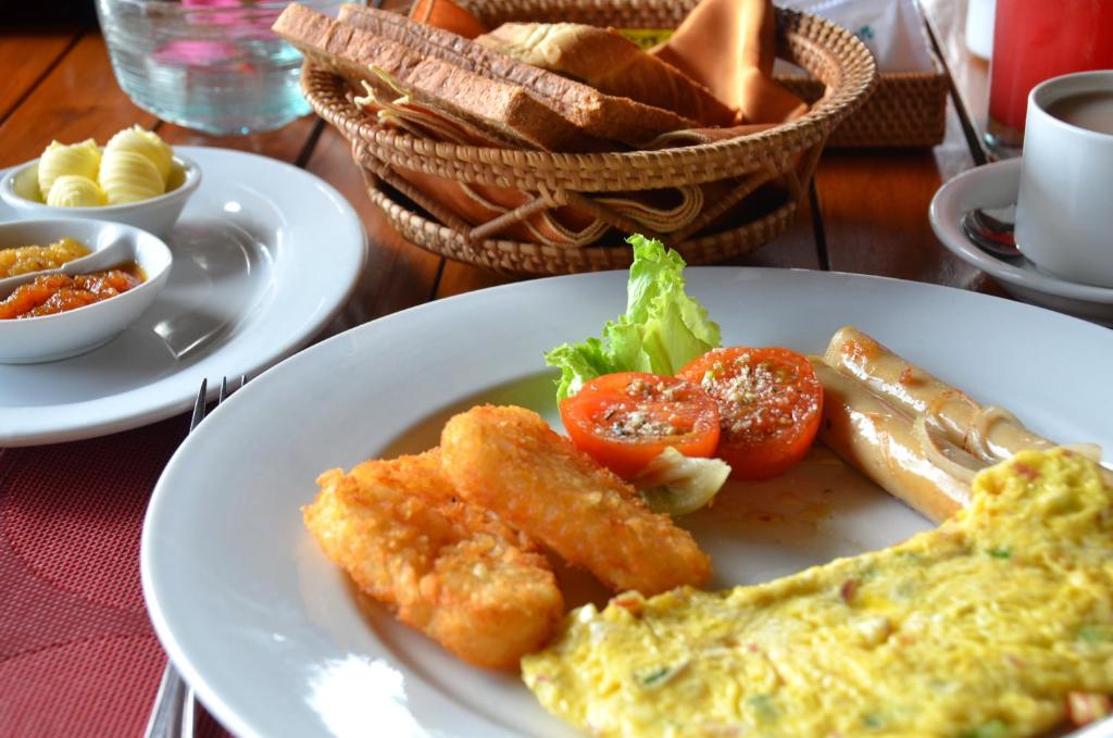 a plate of food with eggs and tomatoes on a table at Cocotinos Sekotong Lombok in Sekotong