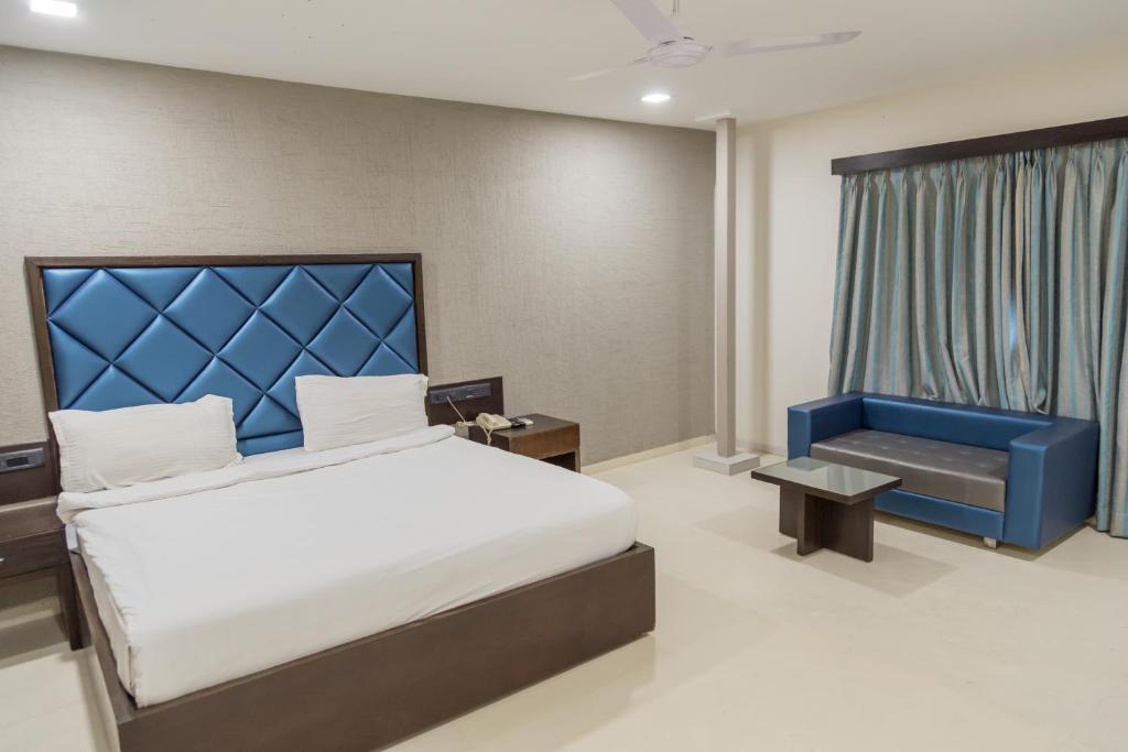 Posteľ alebo postele v izbe v ubytovaní Ginger Ahmedabad, Satellite