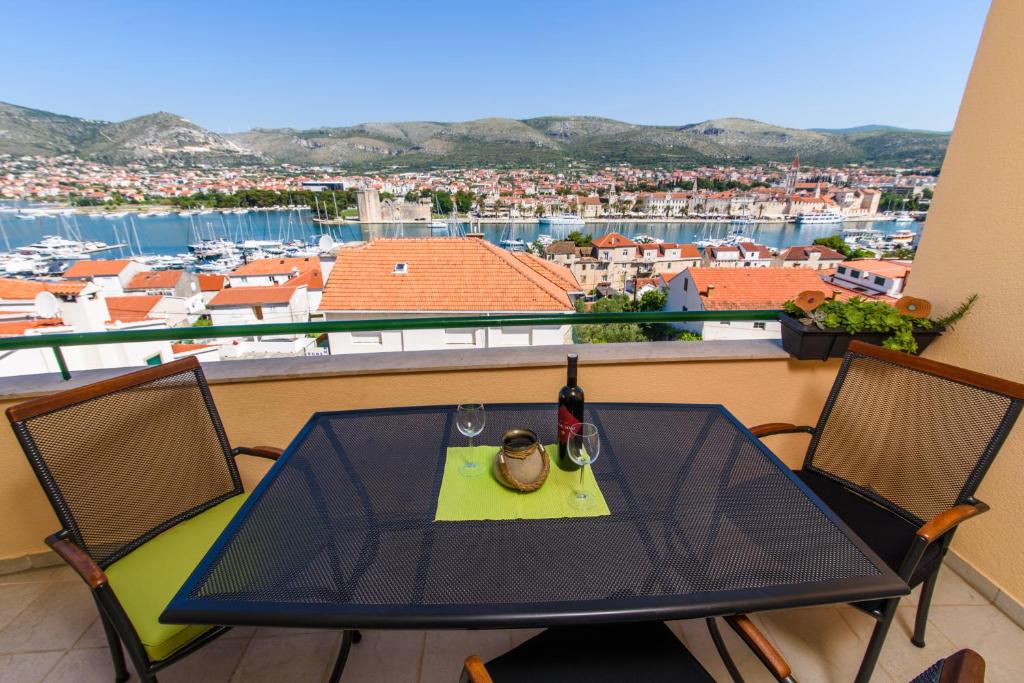 a table and chairs on a balcony with a view at Apartment Trogir City in Trogir