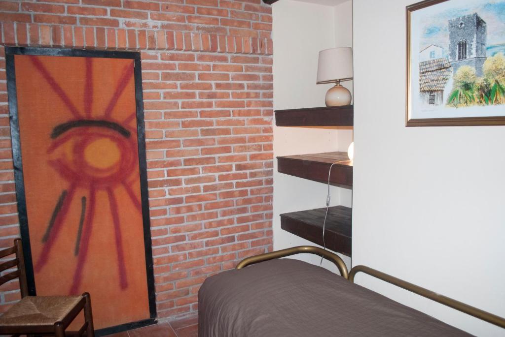 A bed or beds in a room at Agriturismo Fattoria di Grenne