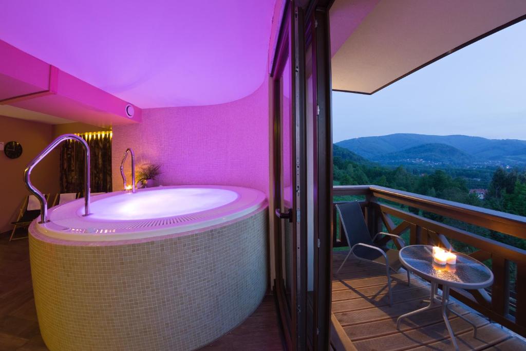 a bathroom with a bath tub on a balcony at Perła Beskidu in Ustroń