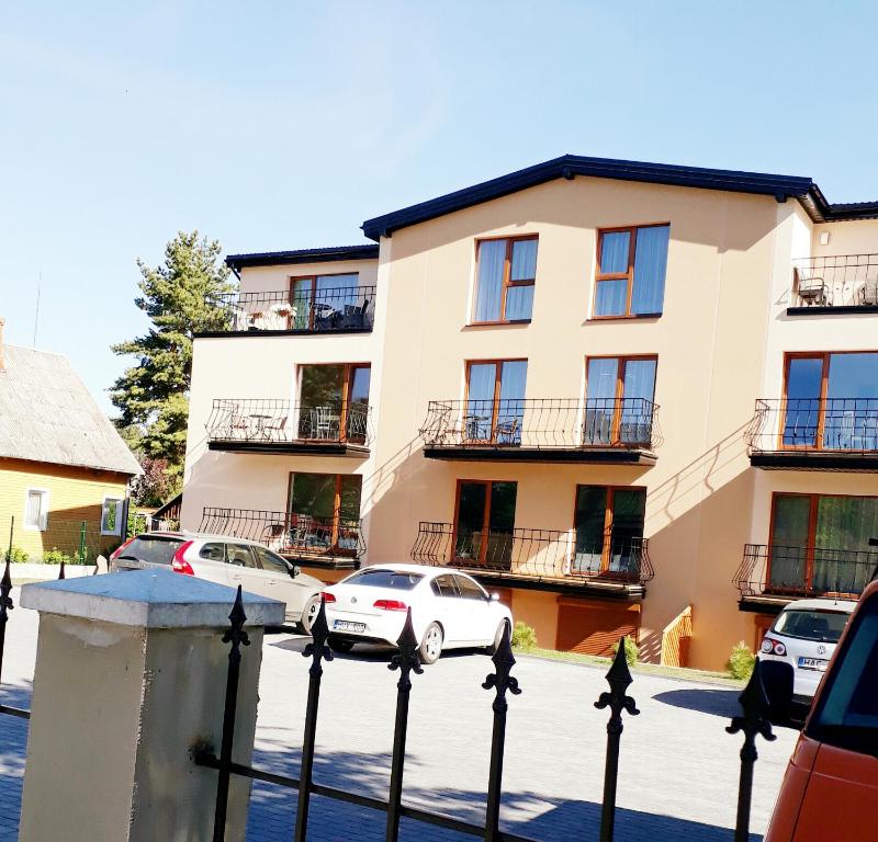 a building with cars parked in front of it at Laimos vila in Palanga