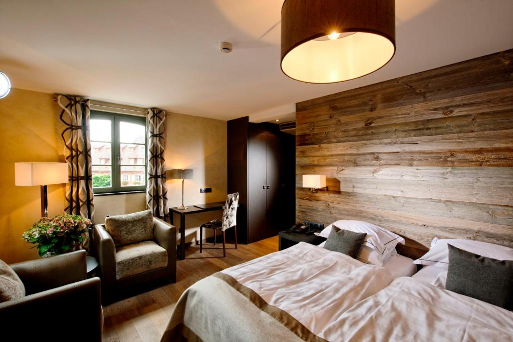 Postel nebo postele na pokoji v ubytování Hotel Restaurant L'Ami Fritz
