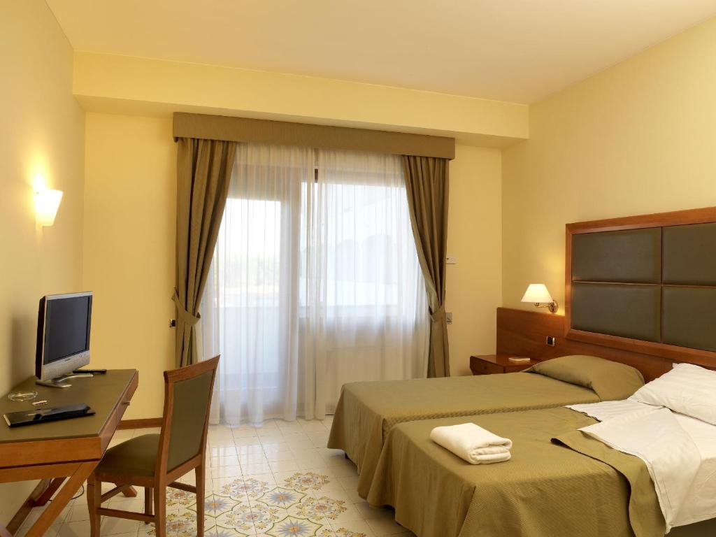 Postel nebo postele na pokoji v ubytování Grand Hotel Don Juan