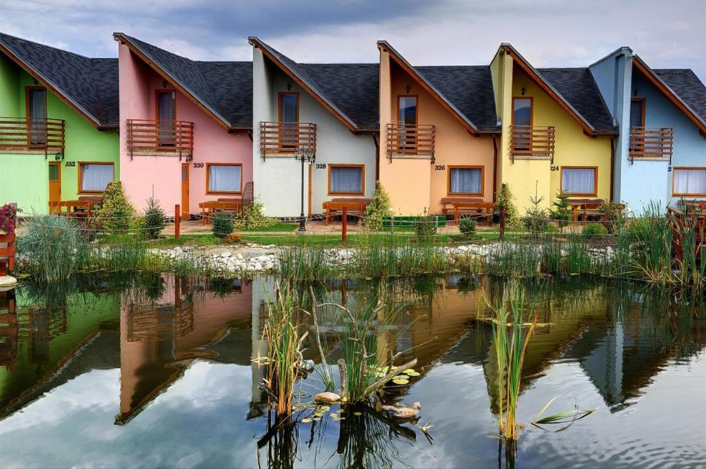 una fila de casas reflejadas en un estanque en Tatralandia Apartmán en Liptovský Mikuláš