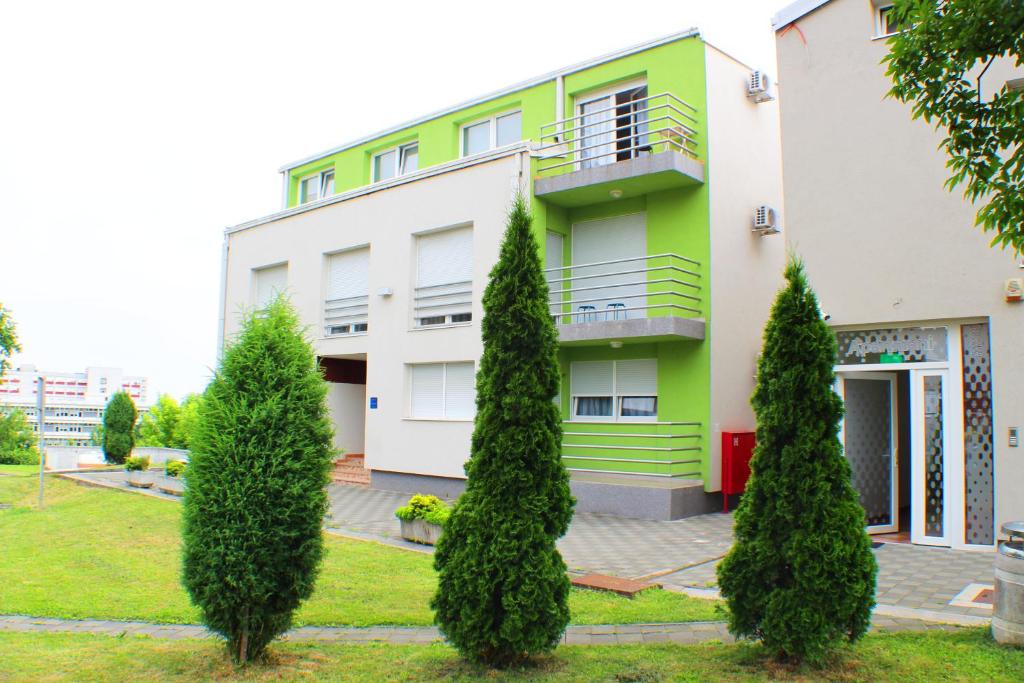 a building with trees in front of it at Bokun Apartments III in Sisak