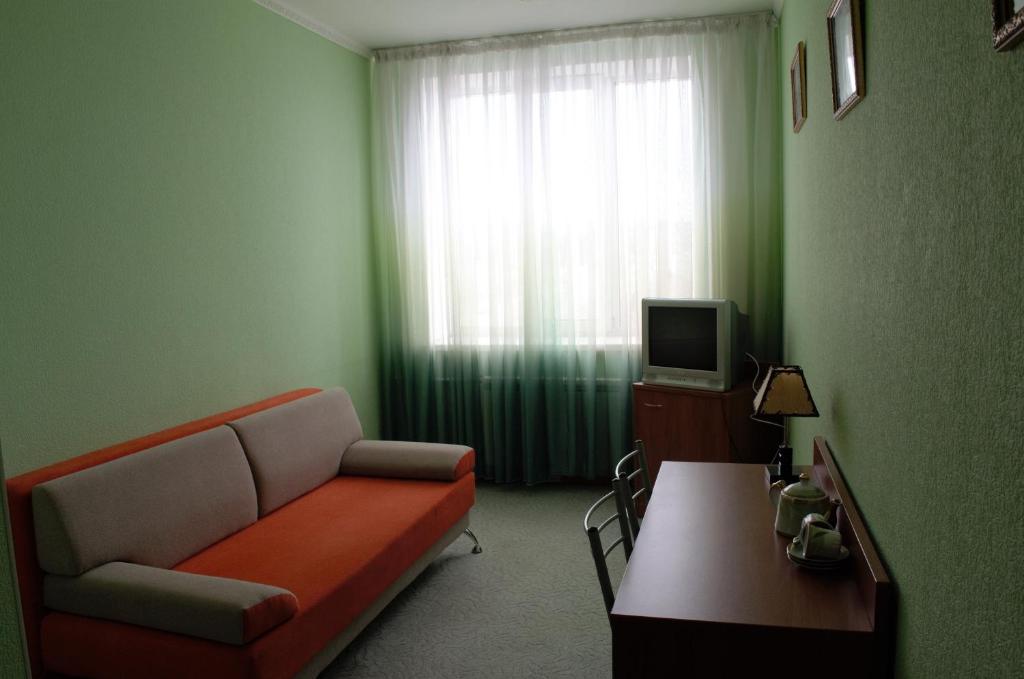 a living room filled with furniture and a tv at Hotel Sultanmurat in Almetyevsk