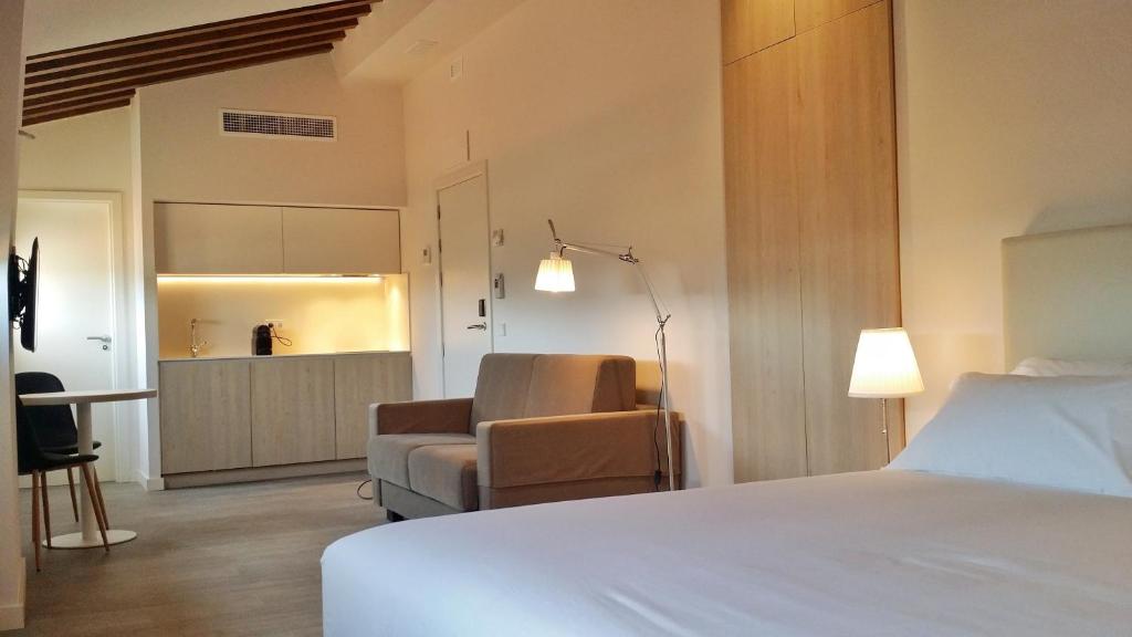 Postel nebo postele na pokoji v ubytování San Lorenzo Suites