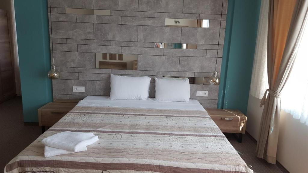 Postel nebo postele na pokoji v ubytování Hotel Emka
