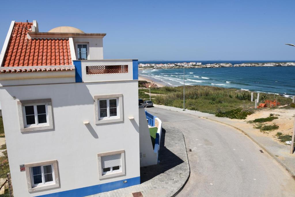 uma casa branca com um telhado vermelho e uma estrada em Villa Pedras Muitas - Baleal no Baleal