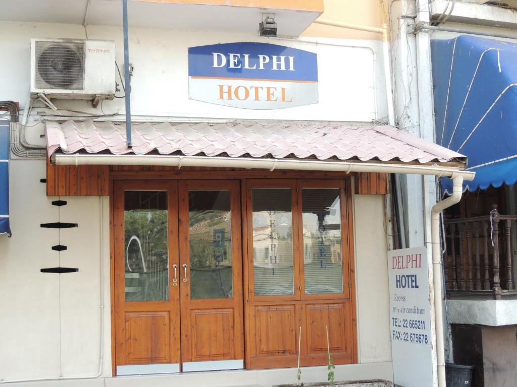 a hotel with wooden doors and a sign above it at Delphi Hotel in Nicosia