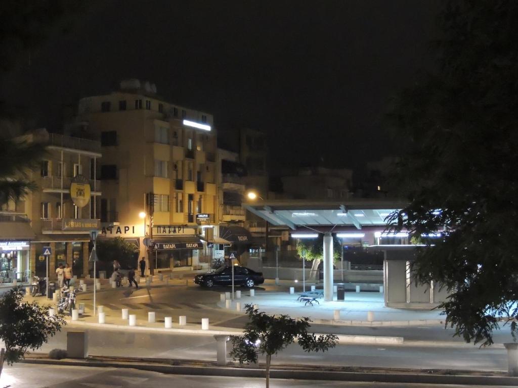 a parking lot at night with a gas station at Delphi Hotel in Nicosia