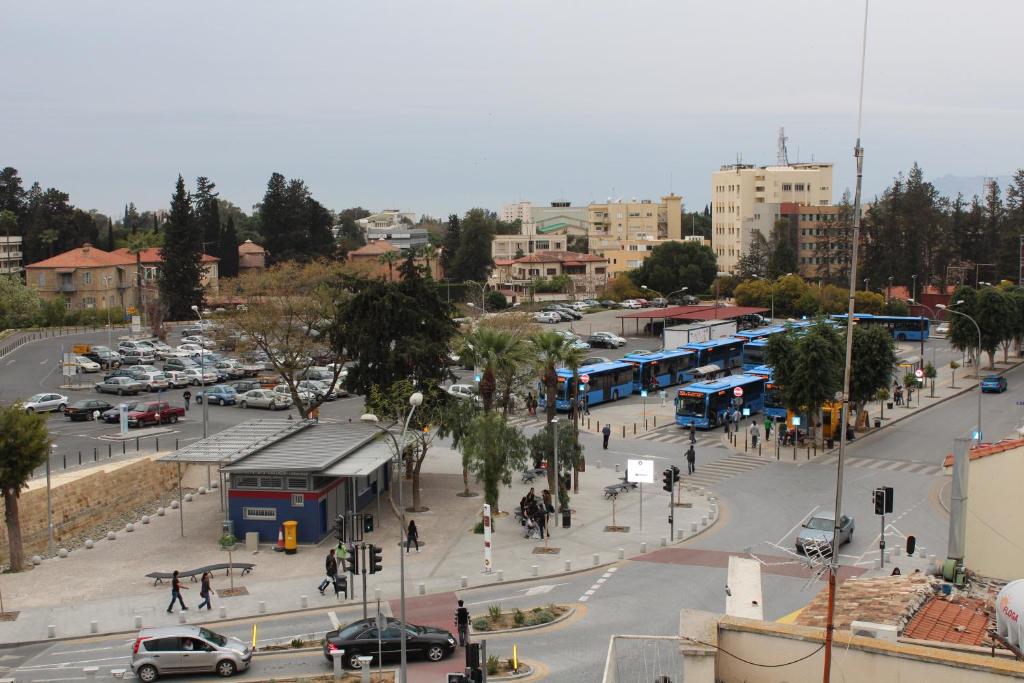 a busy city street with cars and buses at Delphi Hotel in Nicosia