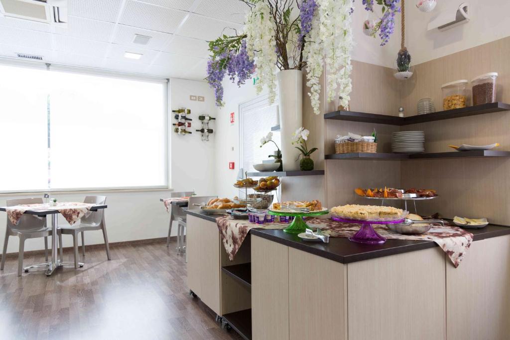a kitchen with a counter with food on it at Hotel Miramare in Pineto