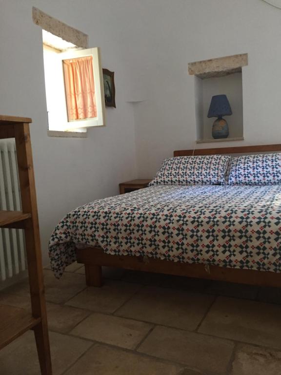 Postel nebo postele na pokoji v ubytování Trulli di Pozzomasiello