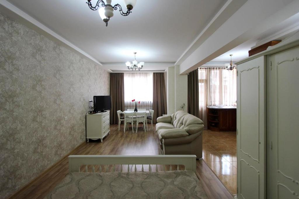a living room with a couch and a table at Luxary apartment near opera & Cascade! in Yerevan
