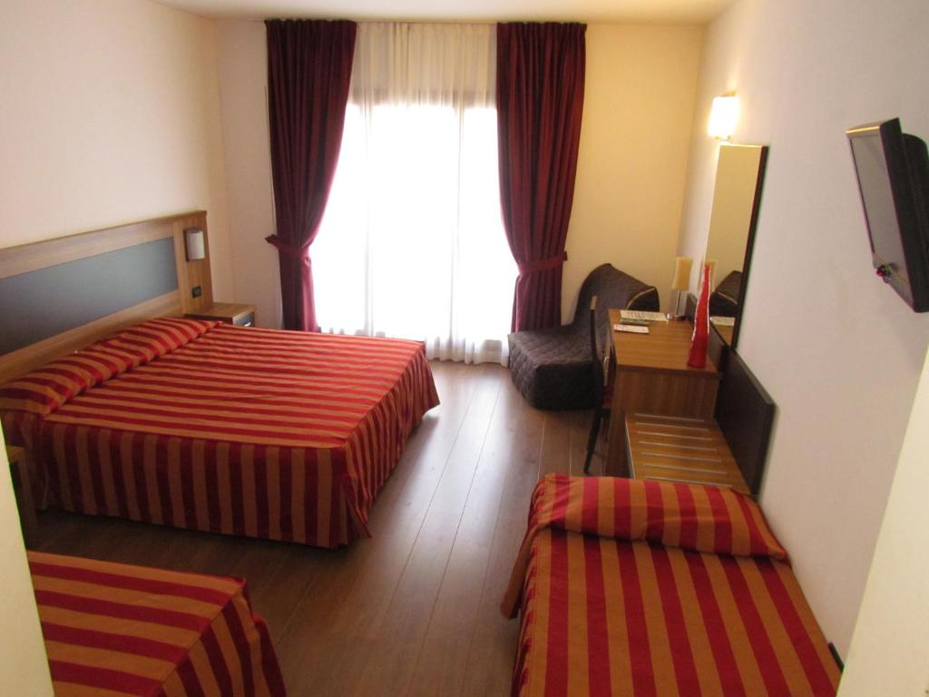 Postel nebo postele na pokoji v ubytování Hotel Leon Bianco