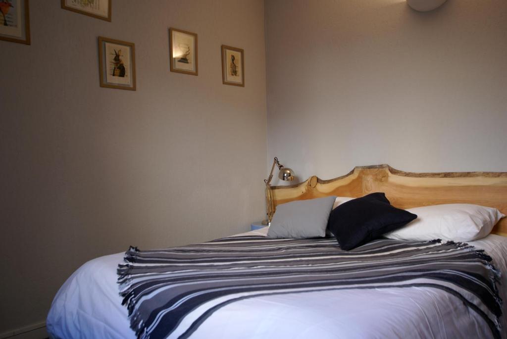 a bedroom with a bed with two pillows on it at Hotel de la Placette Barcelonnette in Barcelonnette