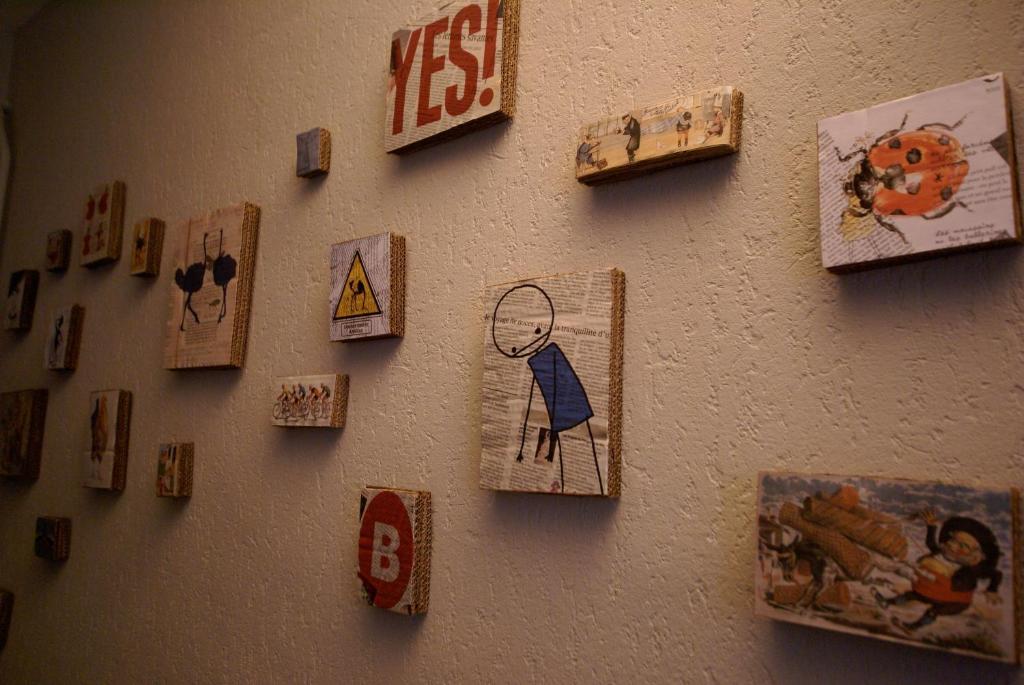 a wall with a bunch of pictures on it at Hotel de la Placette Barcelonnette in Barcelonnette