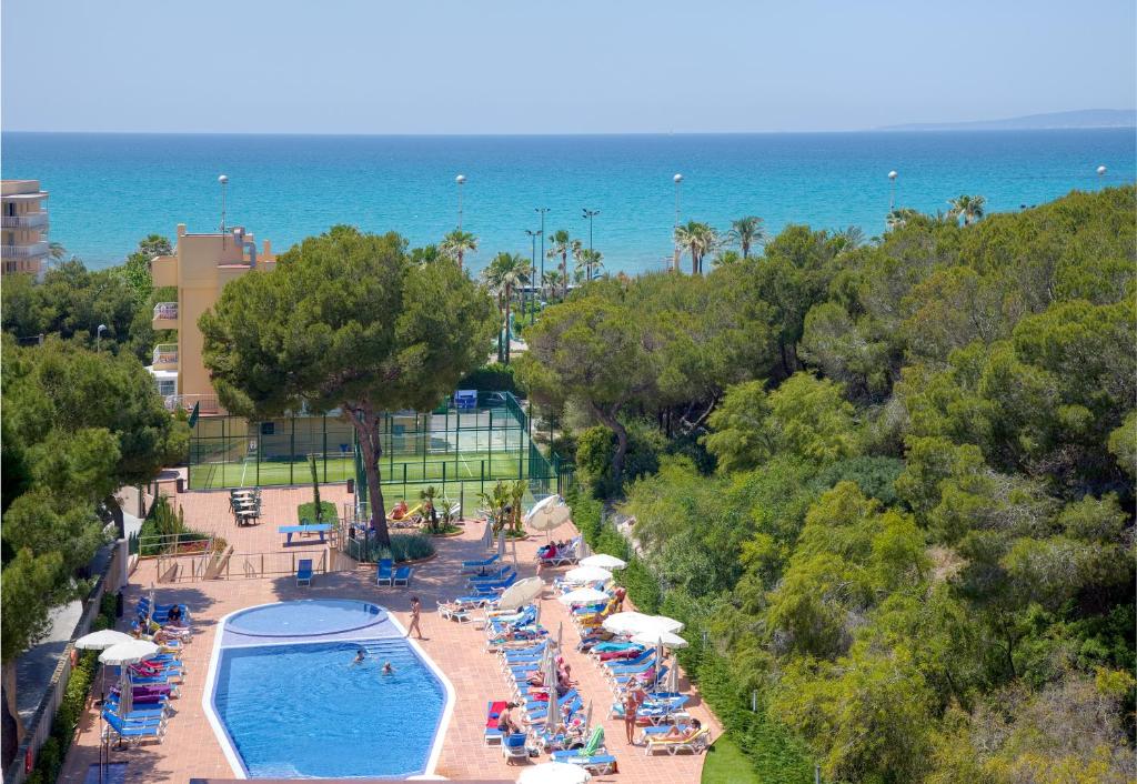 an aerial view of a resort with a pool and the ocean at Hotel Timor in Playa de Palma