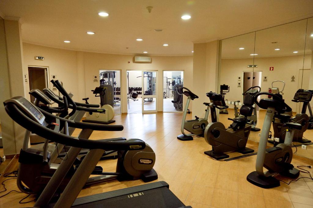 a gym with a bunch of treadms and elliptical machines at Colina Verde Resort in Moncarapacho