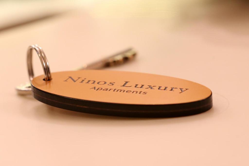 a key chain with the name of nineslinlinicity apartments at Ninos Luxury Apartment in Corfu Town