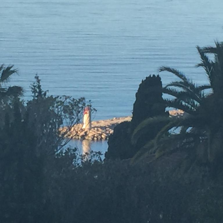 a painting of a lighthouse on a island in the water at Villa Bellochio in Menton