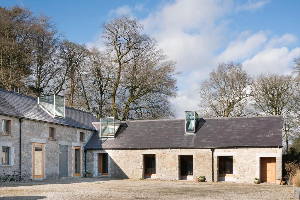 an old stone house with three windows on the roof at June Blake's Garden in Blessington