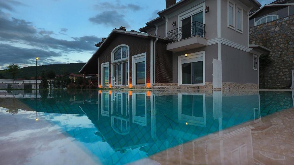 a house with a pool of water in front of it at Pasha Villas in Sapanca