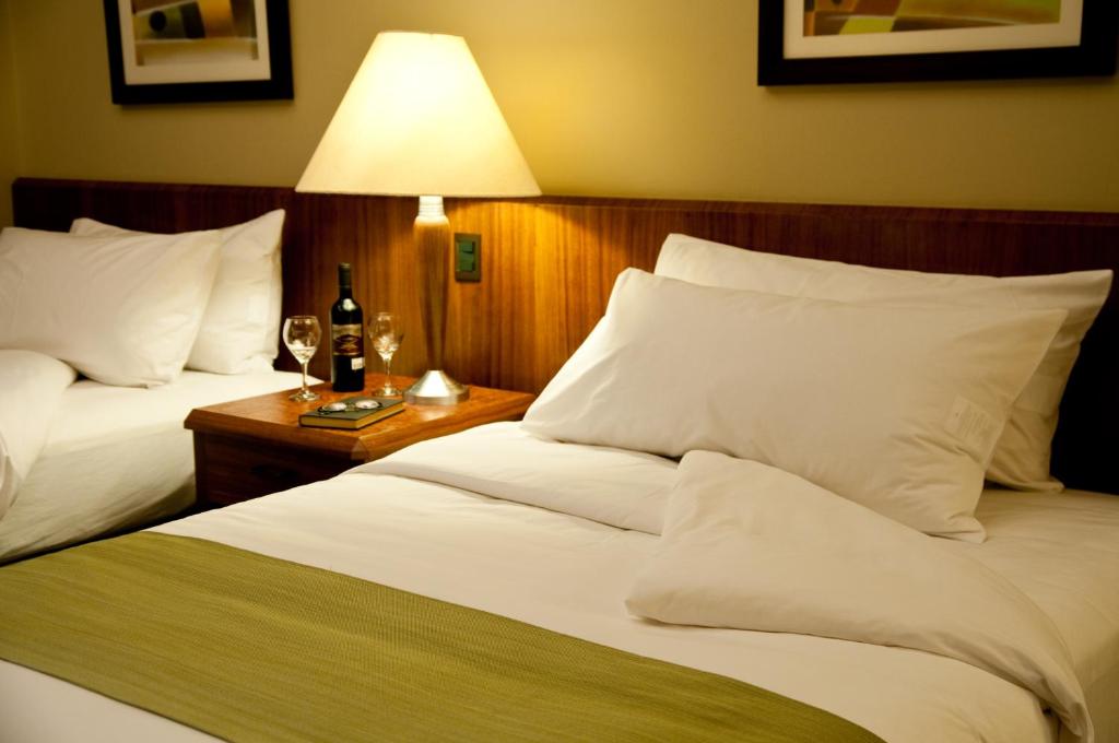 Postel nebo postele na pokoji v ubytování Hotel Palace Guayaquil